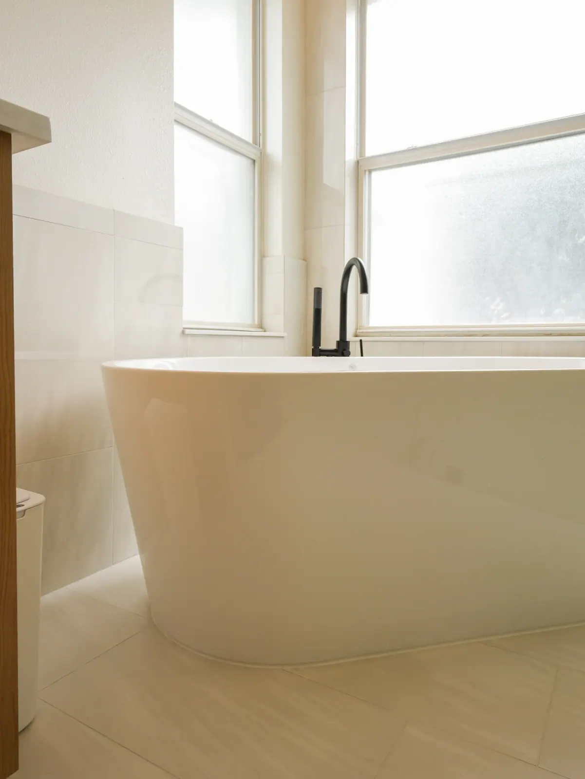 Freestanding tub beneath a window