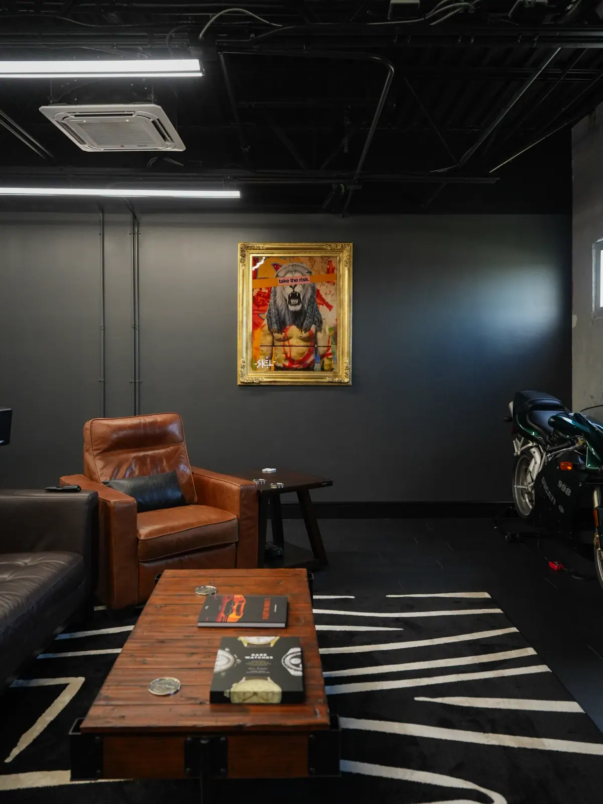 Dark den with a leather chair and framed art