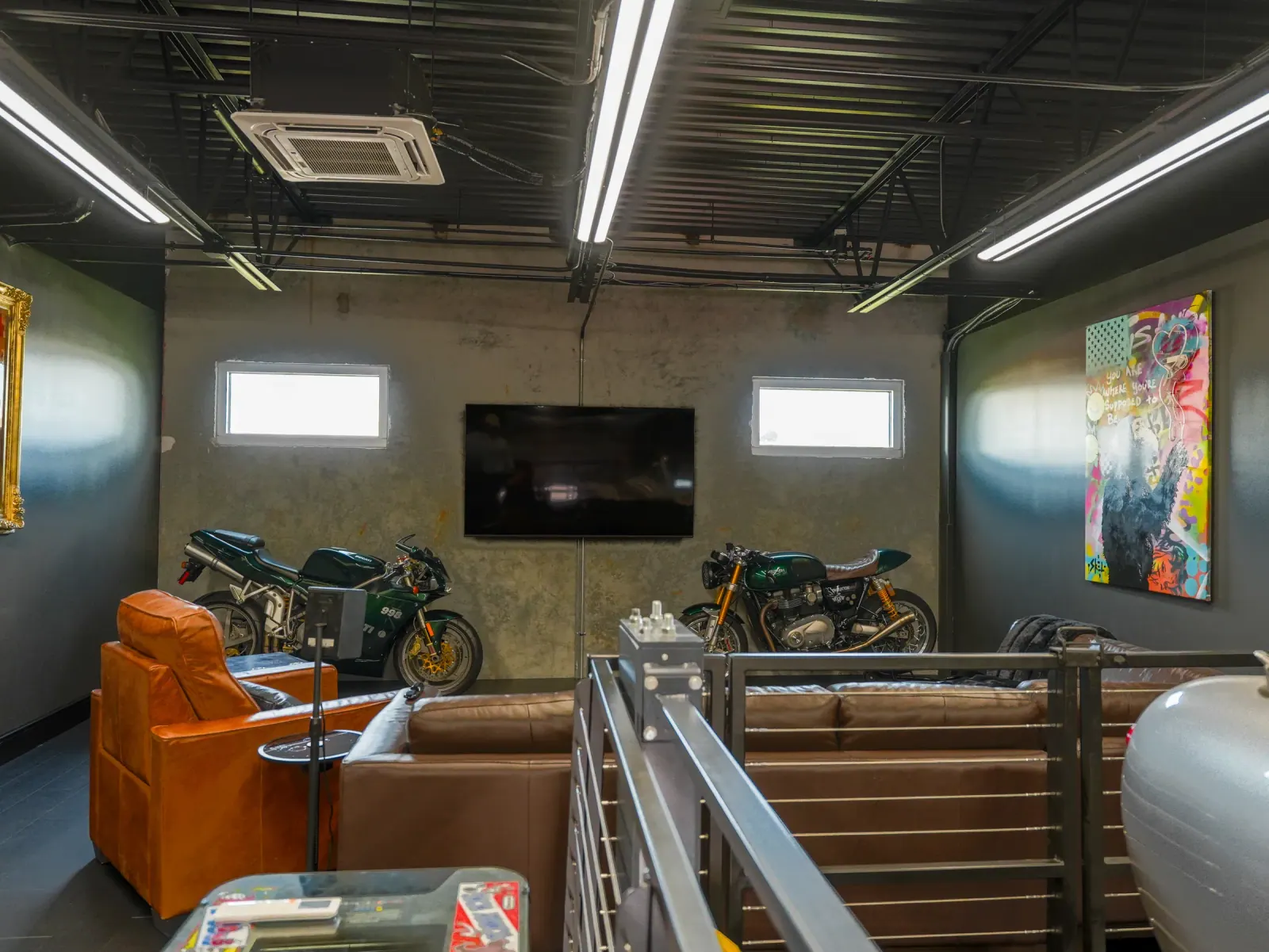 Finished garage lounge with a motorcycle display