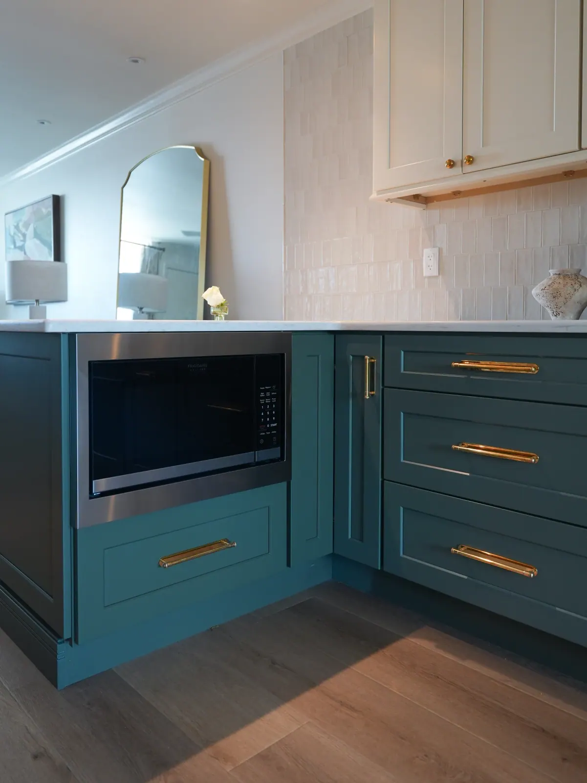 Teal corner cabinets with brass hardware
