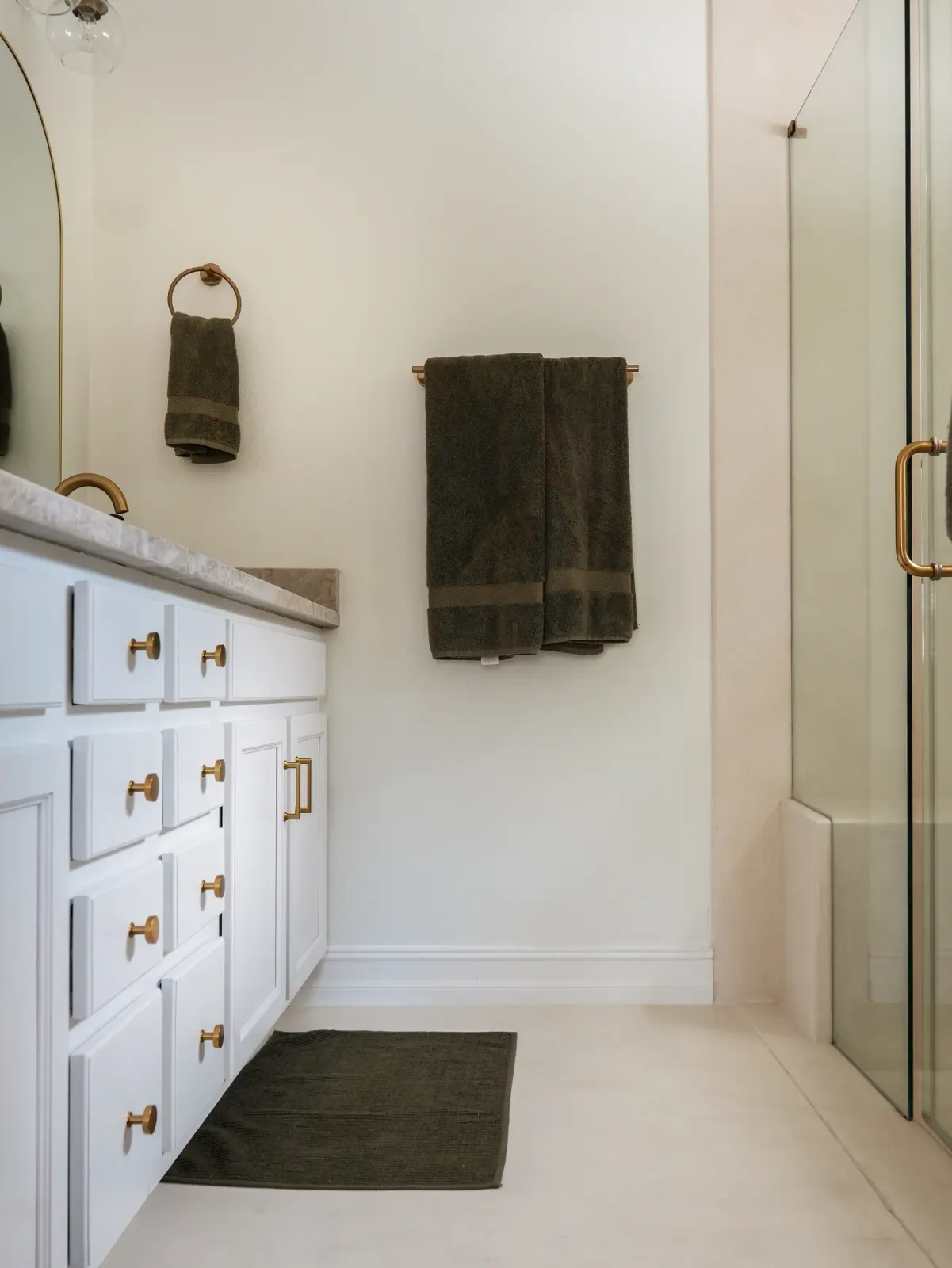 Bathroom with a white vanity and a walk-in microcement shower